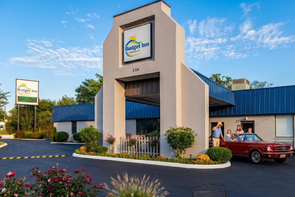 a building with a car parked in front of it at Budget Inn Greenville By Hotel O I-85 in Greenville