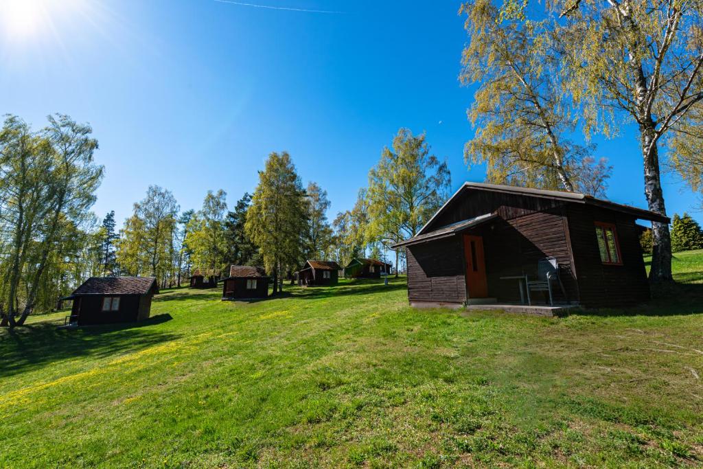 a group of small buildings in a field at CAMP VARY - Vítkova Hora in Karlovy Vary