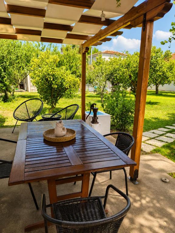 a wooden table and chairs on a patio at SOFIA'S HOUSE No 2 in LESVOS in Apidias Lakos