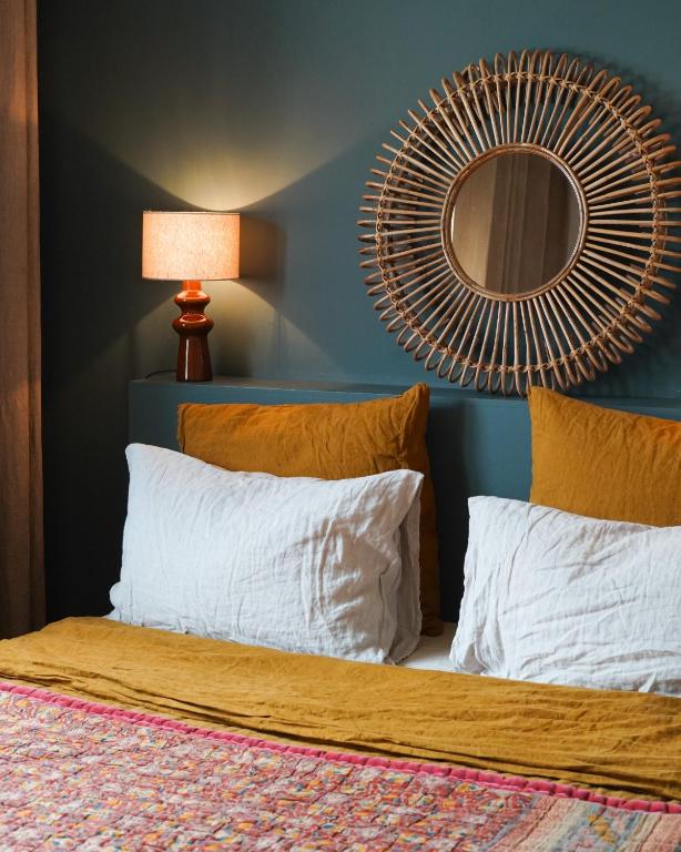 a bedroom with a bed with a mirror on the wall at Chambre confortable Piscine Maison EtxeCosy in Bidart