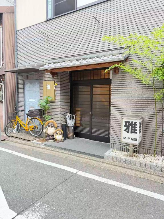 a building with two bikes parked in front of it at 雅 in Kyoto