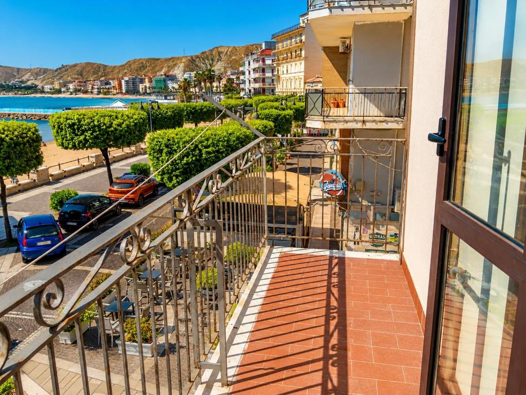 a balcony with a view of a street at Malù camera tripla in appartamento - lungomare Crotone in Crotone
