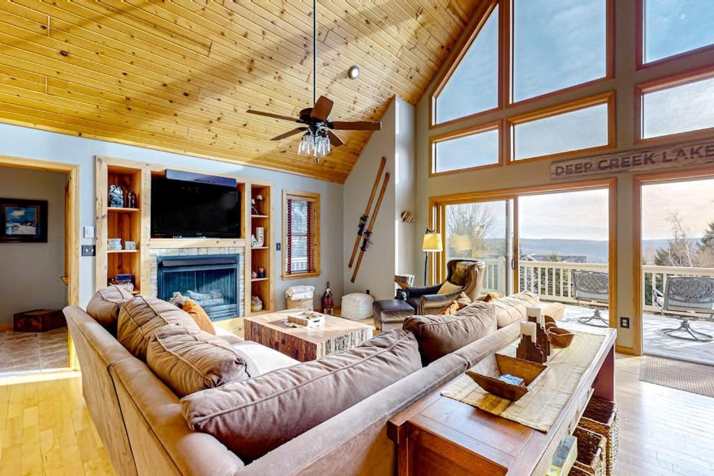 a living room with a large couch and a fireplace at Bear's Eye View in McHenry