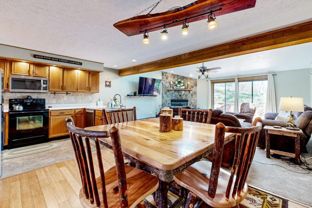 a kitchen and living room with a wooden table at Oakland Oasis in Oakland