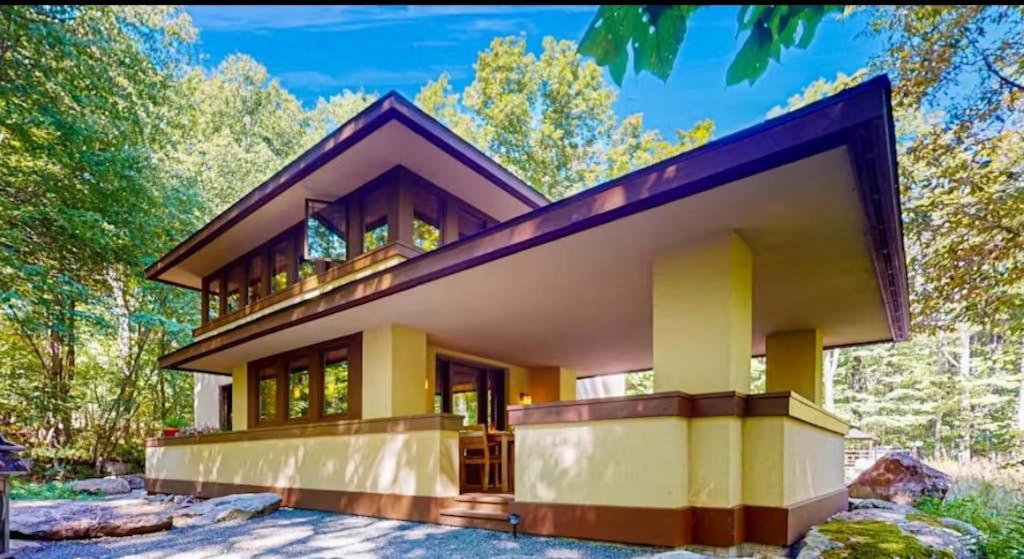 a house in the woods with a large building at The Frank Lloyd Wright Home @ Deep Creek, MD in Bittinger