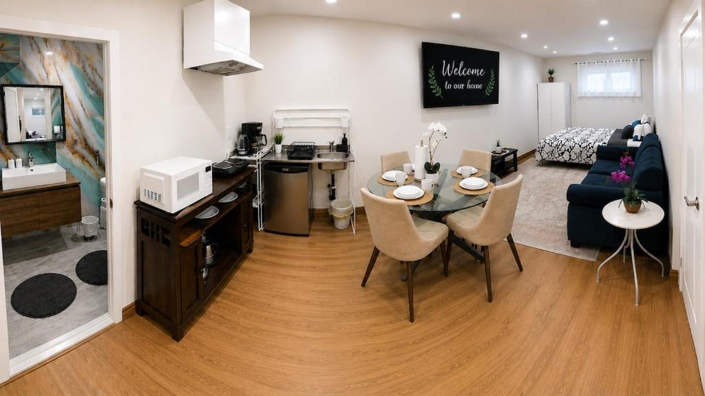 a living room with a dining table and a living room at Azure Glow Studio in Brossard