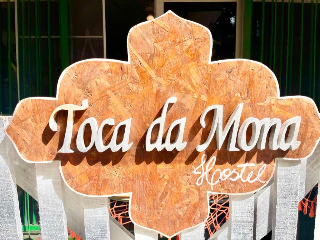 a wooden sign with the words tea miao more at Toca da Mona Roots Hostel in Vitória