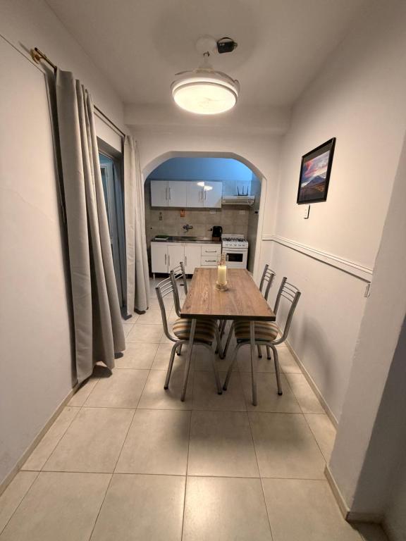 a dining room with a wooden table and chairs at Dunas y Cielo in Tinogasta