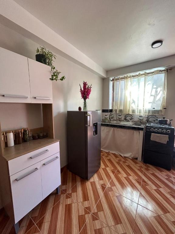 a kitchen with a black refrigerator and a counter at Wiracocha Apartments #2 in Pisac