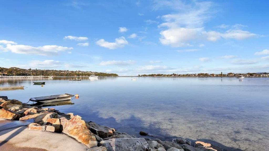 a view of a lake with a boat in the water at SeaLeka 6 in Merimbula