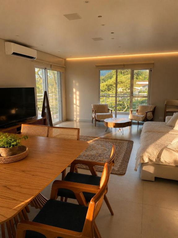a living room with a wooden table and a couch at Lara Country House in Guarulhos