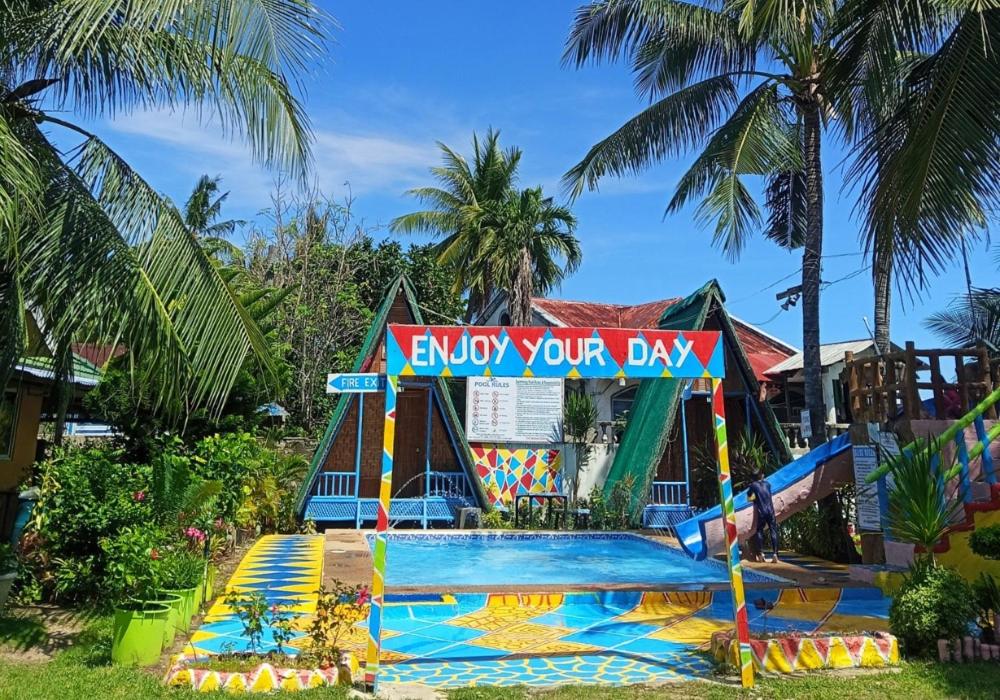 a pool in front of a water park at Mannor Beach Resort by Hiverooms in Carmen