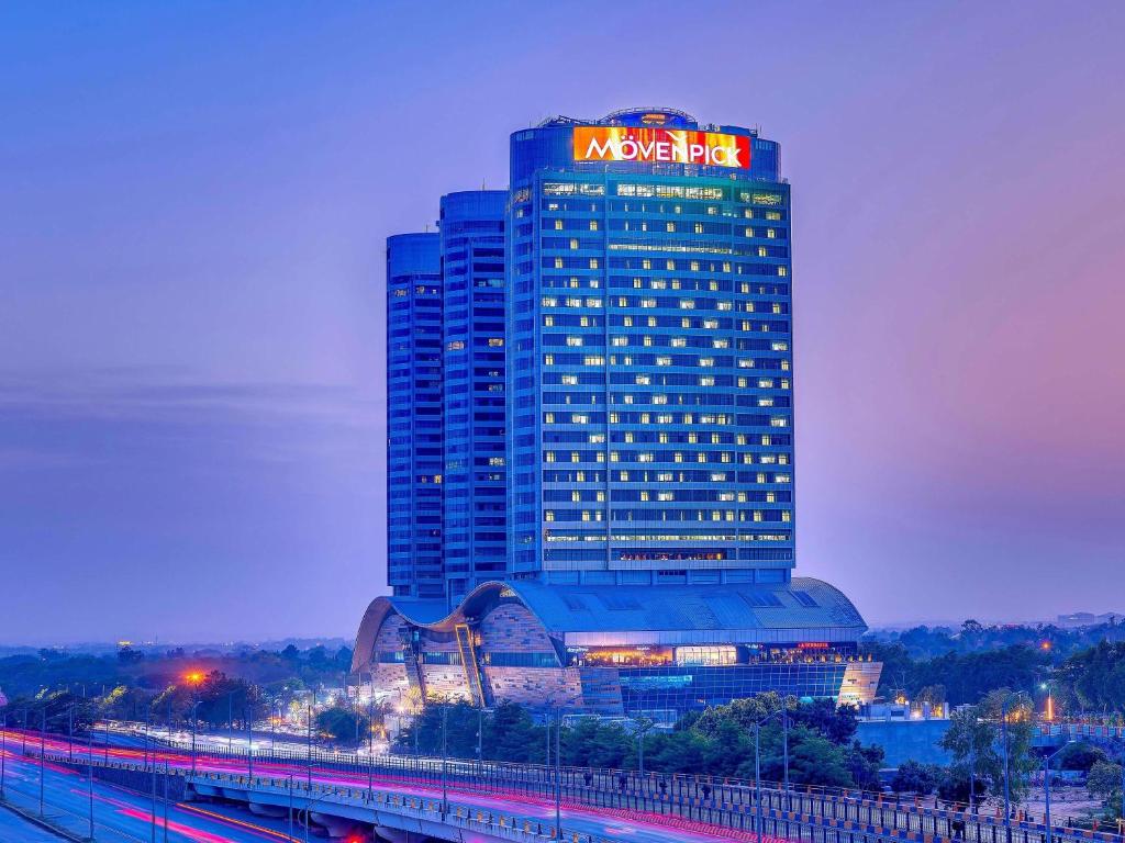 a large building with a sign on top of it at Movenpick Hotel Centaurus Islamabad in Islamabad