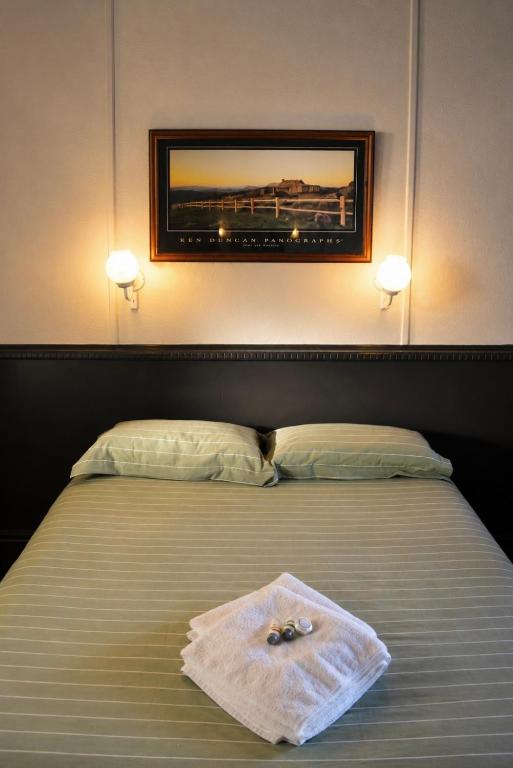 a bedroom with a bed with two towels on it at Warrack Motel in Warracknabeal