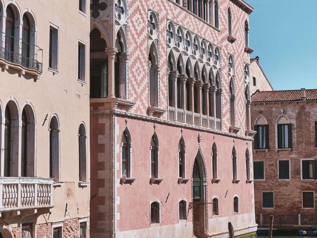 a large brick building with a lot of windows at Orient Express Venezia in Venice