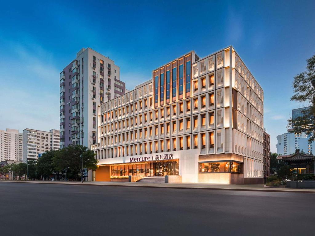 a large building in a city with tall buildings at Mercure Beijing Dongzhimen in Beijing