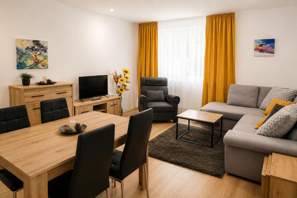 a living room with a table and a couch at T&M Stay Pamporovo in Pamporovo