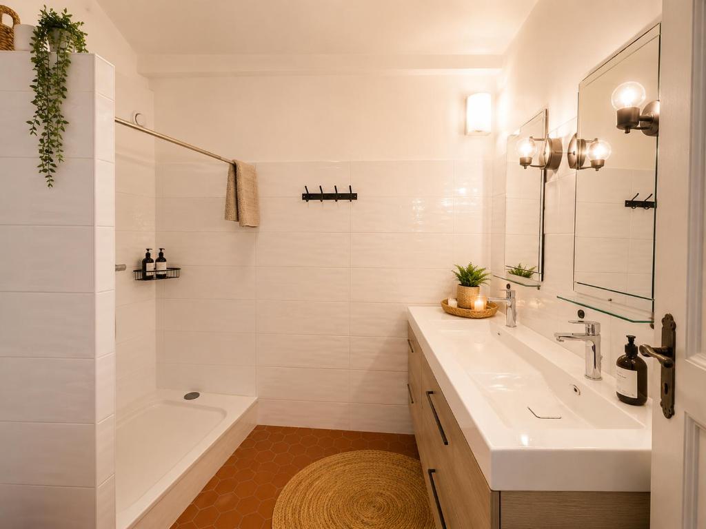 a bathroom with a sink and a tub and a shower at La Maison de Verdun in Sainte-Maxime