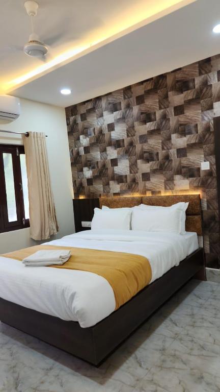 a bedroom with a large bed with a wooden wall at Dhulikhel Training center in Dhulikhel