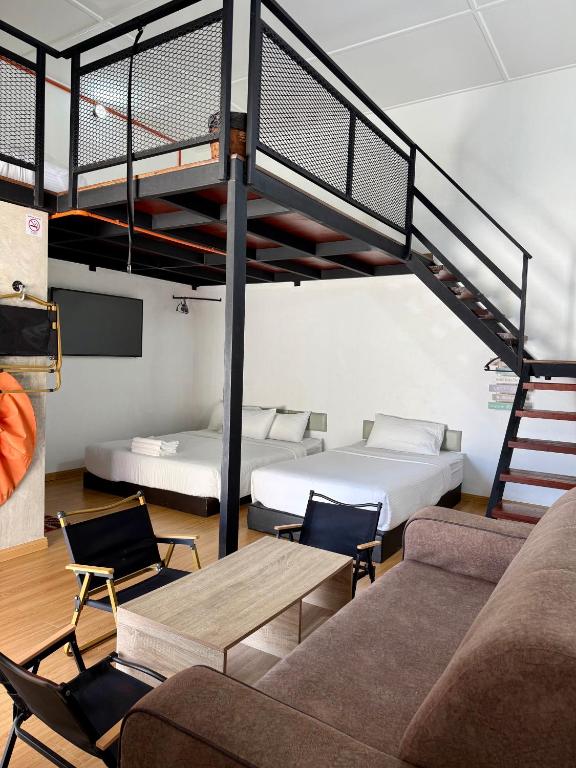 a living room with two beds and a loft bed at Ardour Lodge "A" Wing in Tanjung Bungah