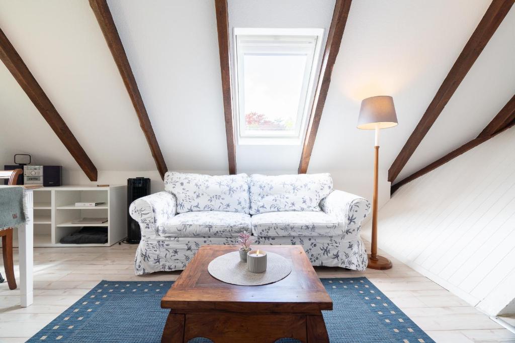 a living room with a couch and a coffee table at Möhlenblick in Neustadt in Holstein