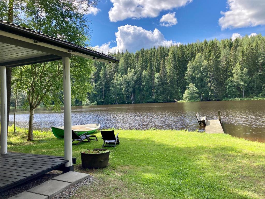 a view of a lake with a dock and a boat at saunamökki Rauhala,LaatuLomat in Juva
