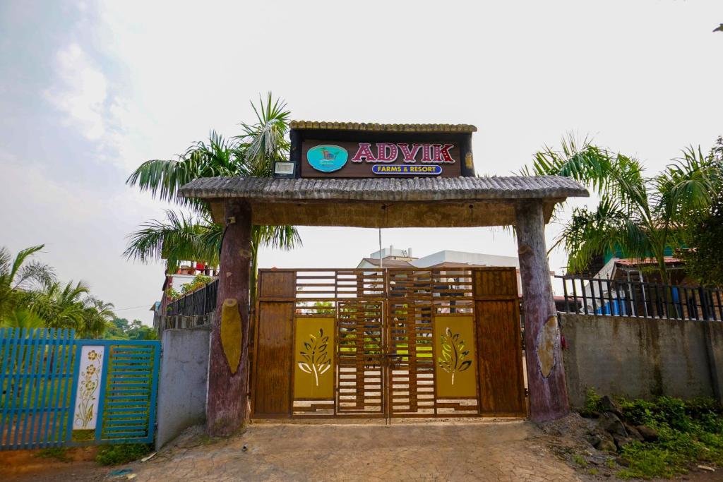 a gate with a sign on top of it at Advik Resort in Badlapur
