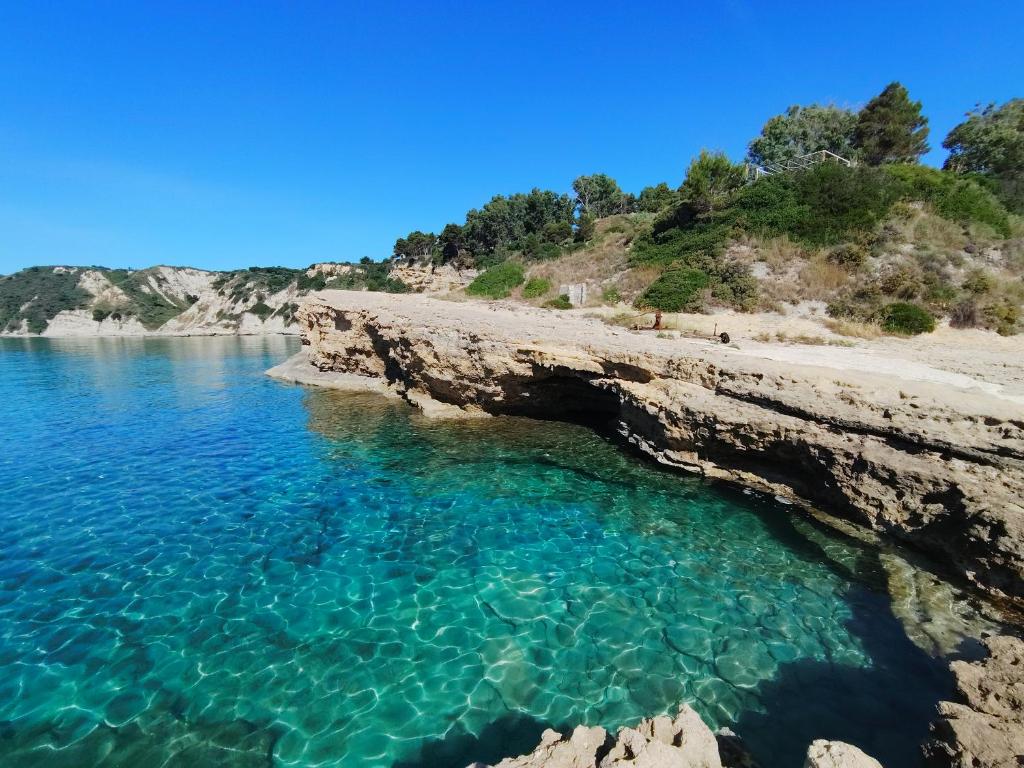 a view of a beach with turquoise water at Klimatsias Beach Apartment in Pesádha