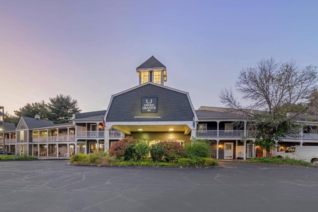 a building with a clock tower on top of it at The Green Granite North Conway, an Ascend Collection Hotel in North Conway