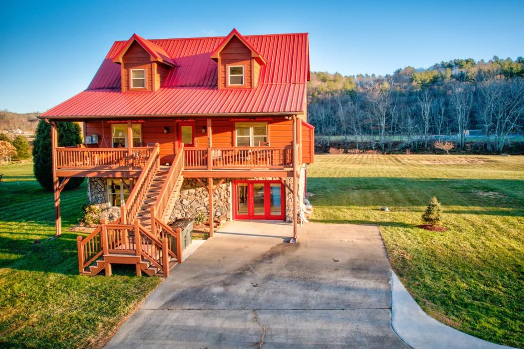 a large wooden house with a red roof at New River Ramble in Todd