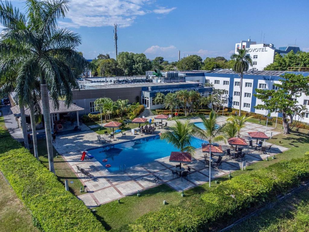 an aerial view of a resort with a pool and palm trees at Novotel Manaus in Manaus