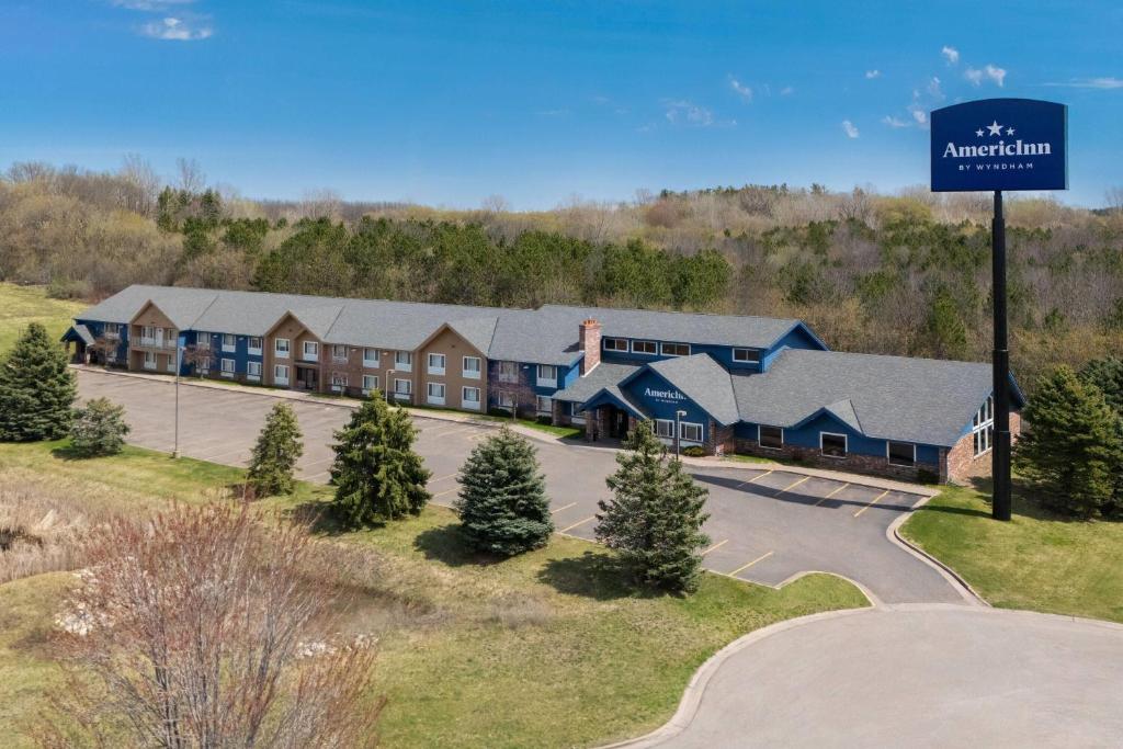 an aerial view of a resort building with a street sign at AmericInn by Wyndham Baldwin in Baldwin