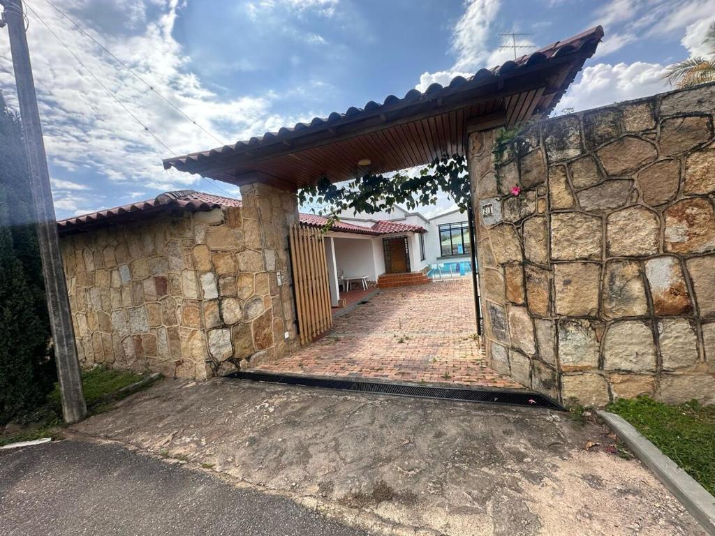 an entrance to a stone house with a stone wall at Prima verde in La Serena