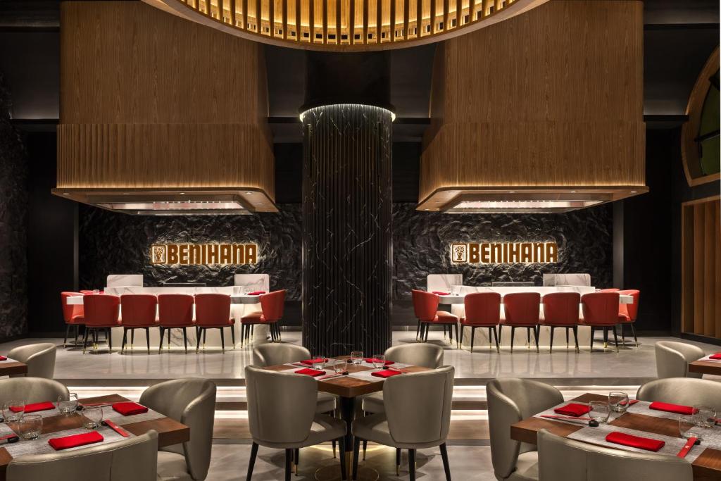 a restaurant with tables and chairs and a fountain at Oaks Ibn Battuta Gate Dubai in Dubai