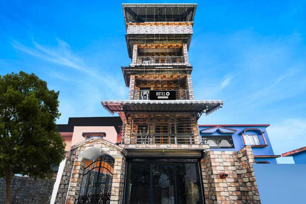 a tall tower on the side of a building at Hotel O Champasari Siliguri Formerly Four Fox Suits in Siliguri