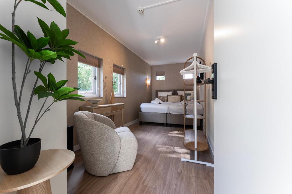 a living room with a bedroom with a bed at Nature Stay near Tilburg Uni & Center in Tilburg