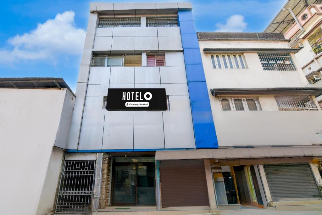 a building with a hotel om sign on it at Hotel O Kanchenjunga Stadium Formerly Bindhan's Inn in Siliguri