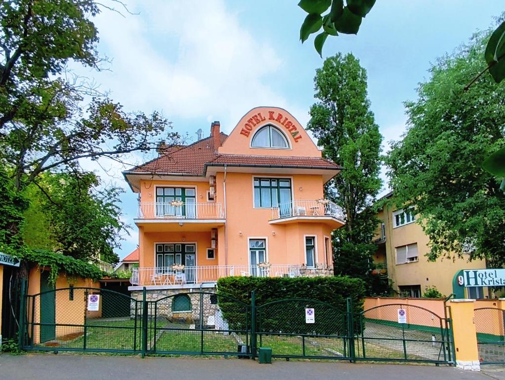 an orange house with a red roof at Villa Kristal Hotel in Budapest
