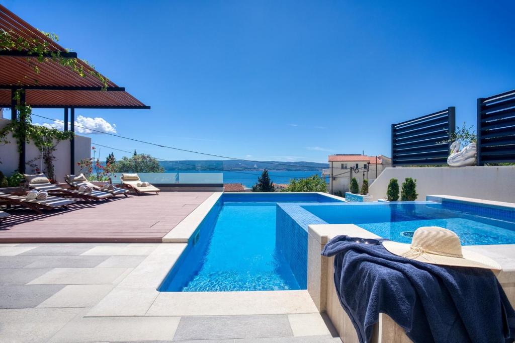 a swimming pool on the roof of a house at LUXURY VILLA PARADISE 120m from sandy beach, heated pool, billiard, max 12 pax in Duće