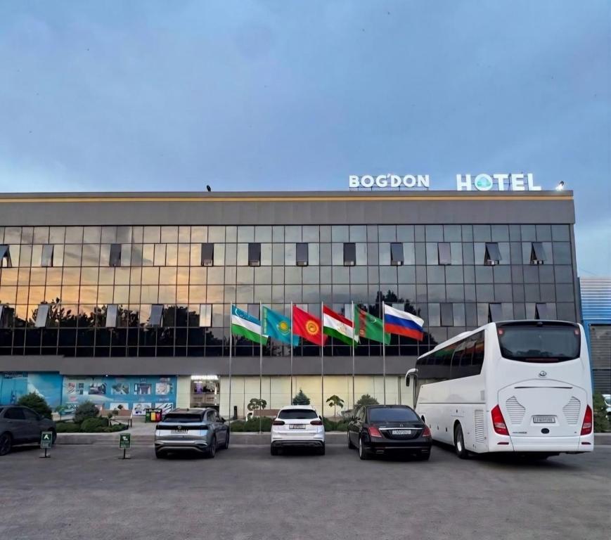 a bus parked in a parking lot in front of a hotel at BOG'DON GRAND Hotel in Tashkent