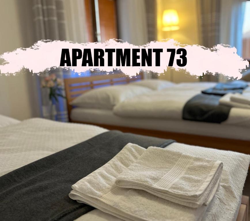 a sign that says appointment with towels on beds at Apartment 73 in Františkovy Lázně