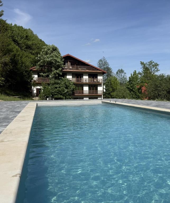 a large swimming pool in front of a house at Domik v gorakh in Bukovets