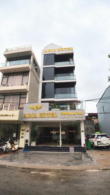 a building with a hotel in front of a parking lot at ARIA Hotel in Ninh Binh