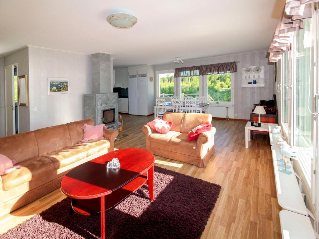 a living room with two couches and a table at Villa Björkholmen in Svartön