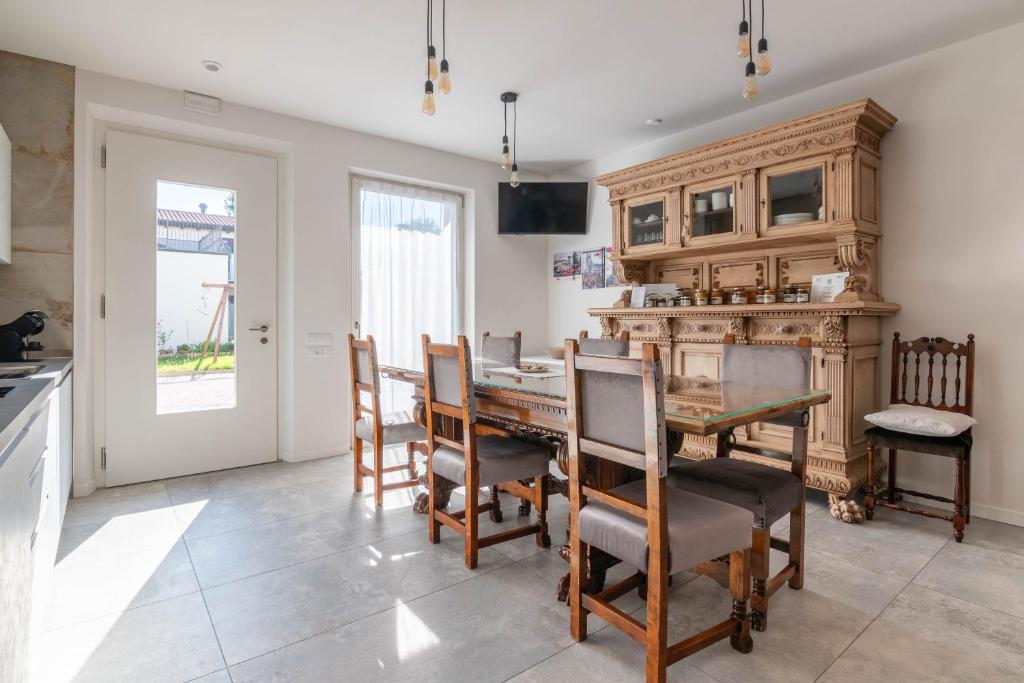 a dining room with a wooden table and chairs at Agriturismo da Natalino in Ceggia