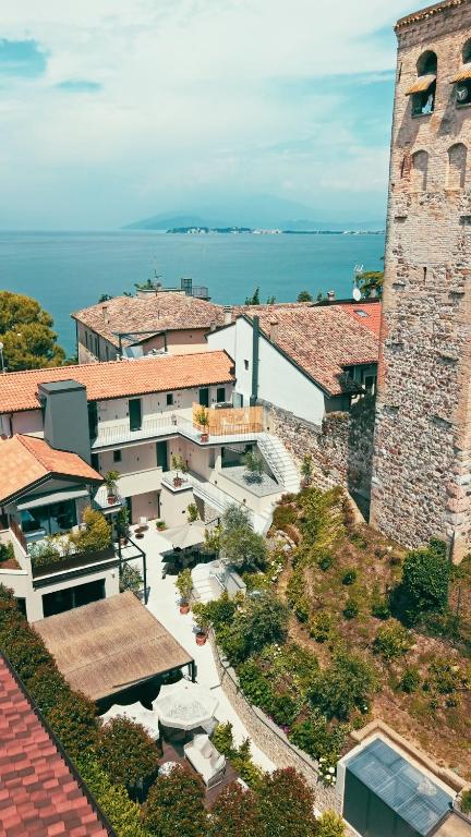 an aerial view of a building next to the ocean at Il Mansio Vegan Hotel and Restaurant in Desenzano del Garda