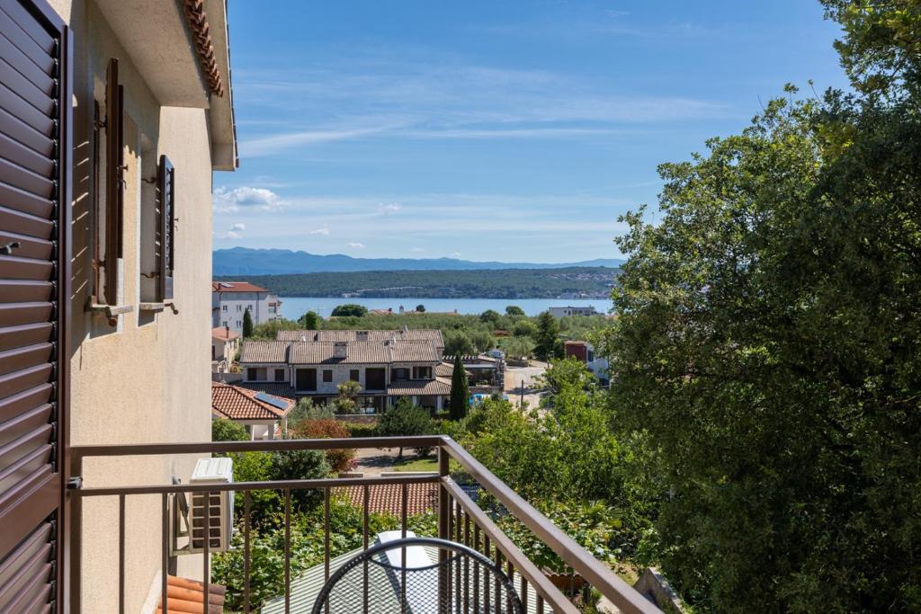 a balcony with a view of the water at Rooms Vera in Porat
