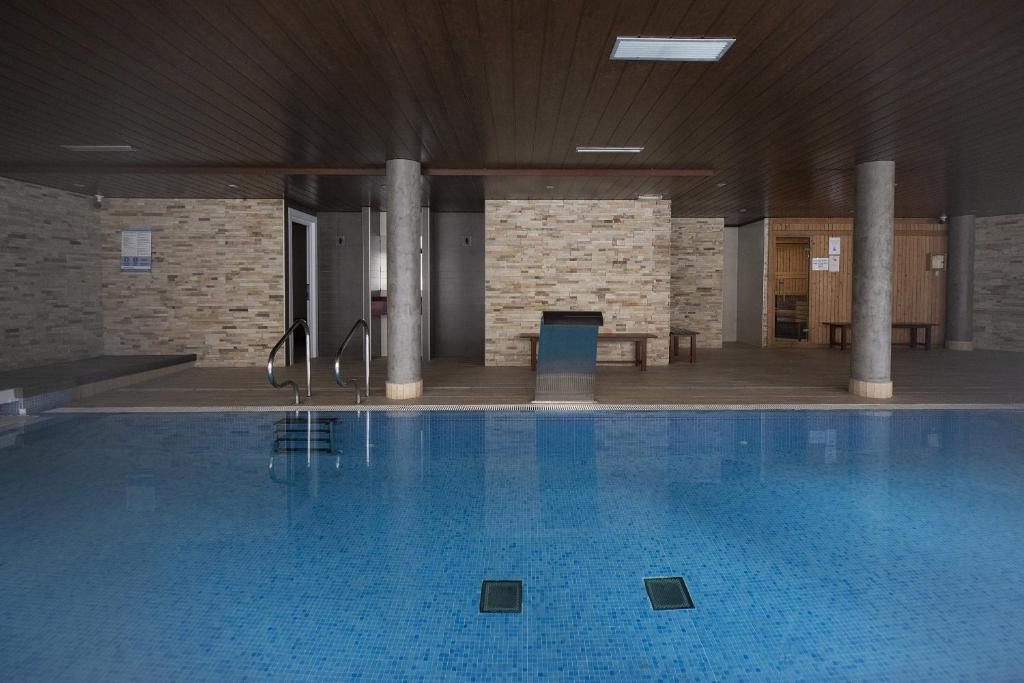 a large swimming pool in a building at Refugio del Roble by BeValle in Panticosa