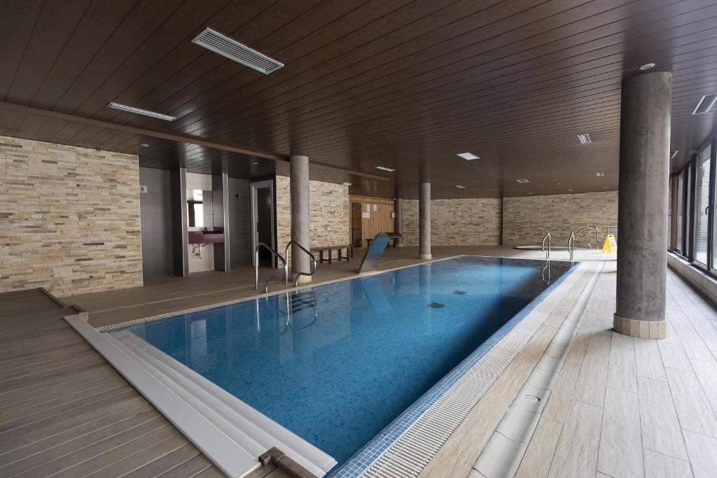 a large swimming pool in a building at Acentor Alpino by BeValle in Panticosa