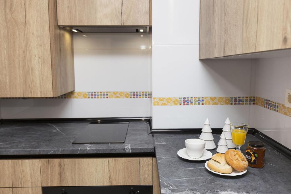 a kitchen with two plates of bread and a laptop on a counter at Casa Lite by BeValle in Escarrilla